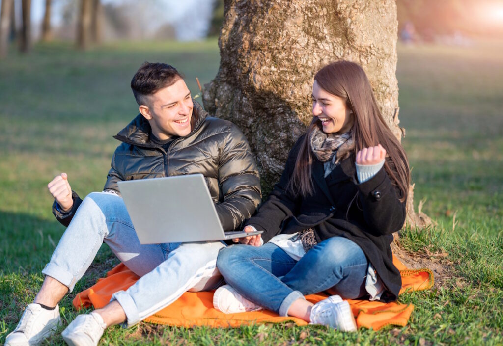 A young couple uses SlickTrip and other travel planning tools to plan their next adventure.